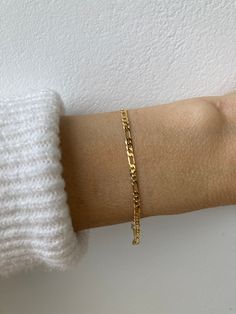 This little bracelet makes a great everyday piece. Wear it alone for a minimal look or stack with other delicate bracelets. D E T A I L S  *Made with a shiny and polished 18k gold filled/rose gold filled figaro chain.  *Chain measures Long Link: 5.5mm x 2.35mm and the Short Link: 3.5mm x 2.4mm *Gold fill is a wonderful alternative to real gold and unlike gold plating does not rub off. It features a real layer of gold pressure bonded to a base metal *It closes with a gold fill spring clasp and all the findings are gold filled too. S I Z I N G *  H E L P *Choose the length from the drop down menu. Use the length guide as a reference.   C A R E * T I P This is a dainty bracelet so please treat it with care. To keep your jewellery in great condition it is always best to avoid water however if Trendy Figaro Chain Bracelets For Everyday, Everyday Figaro Chain Bracelet, Minimalist Figaro Chain Bracelet, Minimalist Yellow Gold Bracelet With Figaro Chain, Minimalist Yellow Gold Figaro Chain Bracelet, Trendy Everyday Figaro Chain Bracelet, Minimalist Tarnish Resistant Rose Gold Charm Bracelet, Minimalist Tarnish-resistant Rose Gold Charm Bracelet, Minimalist Rose Gold Tarnish-resistant Charm Bracelet