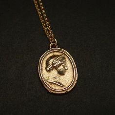 Handmade cameo intaglio reproduction of birthing goddess Juno Hera made into a necklace.Hera was a powerful goddess, the wife and sister of Zeus. She was worshiped as the Queen of Heaven as well as the Goddess of Marriage, Women and Birthing. Hera rules over Mount Olympus as queen of the gods. A matronly figure, Hera served as both the patroness and protectress of married women, presiding over weddings and blessing marital unions.Roman equivalent Juno. As the patron goddess of Rome and the Roman Ancient Greek Jewelry Aesthetic, Goddess Style Engraved Medallion Jewelry, Antique Necklace With Oval Coin Pendant, Antique Coin Pendant Necklace, Antique Oval Coin Pendant Necklace, Antique Gold Cameo Pendant Necklace, Vintage Brass Medallion Necklace, Bronze Cameo Pendant Jewelry, Antique Oval Necklace With Coin Pendant