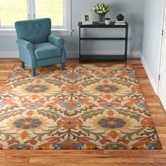 a living room with a blue chair and rug