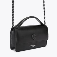 The Extra Small Bond Top Handle Purse is made from a textured leather in black. There is a black eagle head which sits on the front flap and embossed branding below.3.5in (H), 5.9in (L), 1.3in (D)Strap length: 48.4inOptional black chain cross body strap Fits classic credit cardsFlat open pocket on the backInterior: Monogrammed interior liningExterior: LeatherStyle number: 2746500109 Black Textured Leather Crossbody Flap Bag, Black Business Clutch Wallet On Chain, Black Business Wallet On Chain Clutch, Black Wallet On Chain For Business, Black Rectangular Wallet On Chain With Magnetic Closure, Formal Black Wallet On Chain With Magnetic Closure, Black Wallet On Chain For Evening, Black Crossbody Wallet On Chain For Business, Black Business Wallet On Chain Crossbody