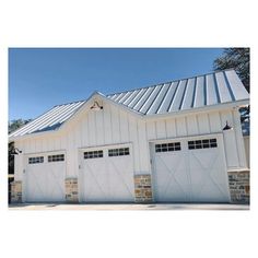 a white garage with two doors and windows