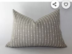 a gray and white striped pillow sitting on top of a table