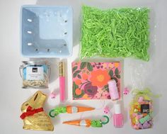 an assortment of crafting supplies laid out on a white surface with green grass in the background