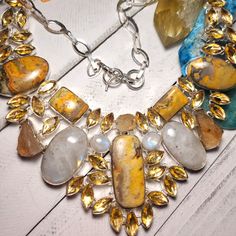 Beautifully Hand Crafted Silver Tone Statement Necklace With 5 Beautiful Bumblebee Jasper Stones , 3 Rough Citrine Stones, 4 Rainbow Moonstones And 43 Citrine Stones. This Is A Big Necklace. The Overall Length Is 20" With A Toggle Clasp. 925 Silver Overlay. Handmade Yellow Citrine Necklaces, Yellow Citrine Jewelry With Stones, Yellow Citrine Stone Jewelry, Elegant Yellow Citrine Jewelry With Stones, Elegant Yellow Citrine Stone Jewelry, Unique Yellow Gemstone Necklaces, Unique Yellow Gemstone Necklace, Unique Yellow Citrine Jewelry, Bumblebee Jasper