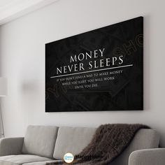 a living room with a couch, lamp and poster on the wall above it that says money never sleeps