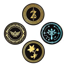 four black and gold badges with symbols on them