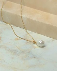 This beautiful pearl drop necklace is created with a genuine seashell pearl briolette strung from a delicate 24k gold filled chain. Chain length is 15 1/2". Matching earrings also available. Teardrop Pearl Charm Necklace In 14k Gold Filled, 14k Gold-filled Teardrop Necklace With Pearl Charm, 14k Gold Filled Teardrop Necklace With Pearl Charm, Gift 14k Gold Filled Pearl Drop Necklace, Gold Teardrop Pearl Drop Necklace, Gold Plated Dangle Pearl Drop Necklaces, Gold Plated Pearl Drop Dangle Necklaces, Briolette Pearl Drop Necklace, Gold Pearl Teardrop Pendant Necklace