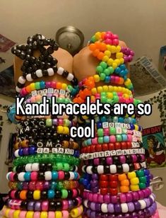 a stack of bracelets with the words kandi braclets are so cool