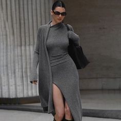 This Women’s Knitted Long Sleeve Sexy Slit Bodycon Dress is crafted from a blend of 95% polyester and 5% spandex, providing a soft and comfortable fabric, perfect for the upcoming autumn and winter seasons. The minimalist solid color design, paired with a stylish slit, exudes elegance and sensuality. The bodycon fit highlights the wearer’s curves, enhancing a slim waistline and graceful leg silhouette. The faux two-piece cardigan-style design adds a modern and trendy touch, making this dress a s Girls Long Dresses, Long Knitted Dress, Winter Mode, Grey Maxi Dress, فستان سهرة, Body Con Dress, Slim Fit Dresses, Ann Demeulemeester, Looks Chic