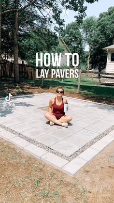 a woman sitting on the ground with her legs crossed in front of her and text overlaying how to lay pavers