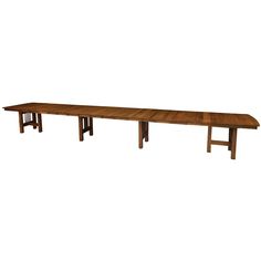 a long wooden table sitting on top of a white floor