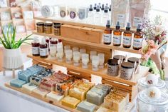 an assortment of handmade soaps and body lotions on display in a store