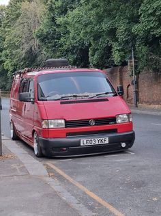 a red van parked on the side of a road