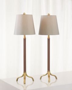 two lamps sitting on top of a white table