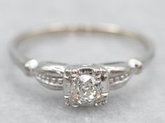 This solitaire ring features a gorgeous Old Mine Cut diamond. The illusion head has a square profile, making the diamond look larger. The shoulders are adorned with engravings, bringing some dimension to this piece. This ring would look great next to any wedding band, from the plain to the ornate.Metal: 18K White GoldGem: Old Mine Cut Diamond .25 Carats, SI in Clarity, H in ColorGem Measurements: 3.6 mm, RoundRing Size: 7Marks: "18K" Stamped on the inside band Engagement Ring Classic, Vintage Diamond Engagement Ring, Classic Engagement Ring, Estate Ring, Old Mine Cut Diamond, Estate Rings, Classic Engagement, Diamond Engagement Rings Vintage, Filigree Pendant