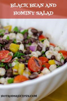 a white bowl filled with black bean and tomato salad