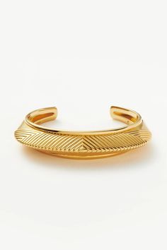 A capsule of sculptural modern-day amulets. This statement chunky cuff bracelet features geometric ridge detailing and a pyramid profile. Textures and geometric patterns combine to signify intuition, inner knowing, and creativity. Available in small, medium and large, style solo or pair with a double chain for an instant arm stack. Metal: 18ct Recycled Gold Plating on Brass Caring for your Jewellery This piece should be stored in a cool, dry place and cleaned carefully with a soft non-abrasive cloth to maintain shine. Chunky Cuff Bracelet, Arm Stack, Inner Knowing, Statement Cuff Bracelet, Finger Bracelets, Gold Bracelet Cuff, Double Chain, Gold Plated Bracelets, Amulets