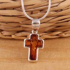 This is 925 Sterling Silver Cross Pendant & Genuine Baltic Amber.    925 stamped         Amber colour: cognac        Approx. pendant measures:                total length: 22mm               without bail: 16mm               width: 10mm Available on its own or with various length (16-26 Inch ) snake chain, please choose from the drop down menu at the top of the page.    Presented in gift box.    Thank you for looking! Classic Orange Jewelry As Gift, Classic Orange Jewelry For Gift, Classic Orange Necklace For Gift, Classic Orange Necklace For Gifts, Orange Polished Finish Jewelry For Gift, Amber Hallmarked Necklaces For Gifts, Brown Hallmarked Sterling Silver Jewelry, Classic Amber Necklace As Gift, Classic Amber Necklace Gift