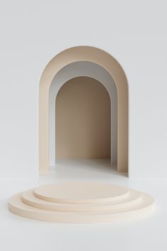 an arch in the middle of three circular bases on a white surface with no one around it