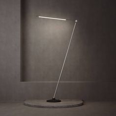 a lamp that is sitting on top of a stone base in a room with grey walls