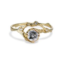 a yellow gold ring with a white diamond in the center