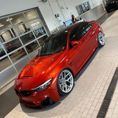 a red car parked in front of a building