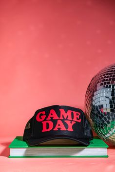 Prepare yourself in style for game day with this cheery cap, available in a range of color combinations. Looking for something more bespoke? Feel free to reach out to us and we'd be happy to accommodate you. Need a different color combo? Head over to our pick and print trucker! This hat is made to order and will ship in 3-5 business days MADE TO ORDER PRODUCTS ARE FINAL SALE Game Day Sports Fan Snapback Hat, Snapback Hat For Game Day Sports Fans, Sports Fan Snapback Hat For Game Day, Trucker Cap With Letter Print For Game Day, Game Day Sports Fan Hats With Letter Print, Sports Fan Hat With Letter Print For Game Day, Letter Print Trucker Hat For Game Day, Game Day Sports Fan Cap, Sports Fan Cap For Game Day