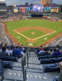 a baseball stadium filled with lots of people sitting on the bleachers watching a game