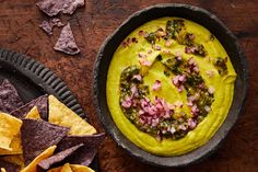 a bowl of guacamole and tortilla chips