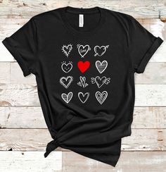 "-♥ ♥ ♥ HOW TO ORDER A TEE ♥ ♥ ♥ 1. Please, Check all Photos. 2. Select Your T-Shirt Style and Size. 3. Select Your Product Color. If you don't find your color just write me a message. I have more. 4. Choose The Quantity. 5. Click ADD TO CART and you can go back to add more items for your friends and family members. 6. Click \"Proceed to Check Out\" 7. Your Shirt will be ready to ship 3-5 Business Days. This T-shirt is perfect for Valentine`s Day, Birthday and Christmas gift. ♥ Fulfilled and pri Black Short Sleeve T-shirt With Heart Print, Black Heart-shaped Graphic Tee, Casual Valentine's Day T-shirt With Heart Graphic, Valentine's Day Cotton T-shirt With Heart Print, Heart Shaped Graphic T-shirt For Valentine's Day, Heart-shaped Graphic Print T-shirt For Valentine's Day, Cotton T-shirt With Heart Print For Valentine's Day, Casual Heart Print T-shirt For Valentine's Day, Black Crew Neck T-shirt With Heart Print