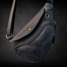 "The Fit Bag Indigo model is made of cowhide leather with a \"Crazy Horse\" finish. The peculiarity of this material is that in the process of operation, the effect of \"aging\" appears, which gives the product a special charm and charisma. Hardware, \"old brass\" colors, also play an important role in the vintage look of the accessory. It has two main compartments, a shoulder strap with leather inserts and a protective flap.  It is possible to increase the volume of the bag by opening the zipper on the outside.  Size 32 cm × 20 cm × 5 cm. Belt circumference 120 cm. Whether it's a casual day out or a business meeting, this crossbody bag offers convenience and style. It's also a great option for a Father's Day gift or a personalized gift set for men. With its adjustable strap and compact de Leather Chest Bag With Leather Lining For Travel, Leather Pouch Chest Bag For Travel, Leather Shoulder Chest Bag For Everyday Use, Leather Chest Bag With Leather Lining For Everyday Use, Leather Chest Bag For Everyday Use, Leather Chest Bag For Daily Use, Soft Leather Chest Shoulder Bag, Leather-backed Crossbody Chest Bag For Daily Use, Leather Backed Crossbody Chest Bag For Daily Use