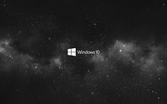 the windows 10 logo is shown in front of some dark clouds and stars on a black background