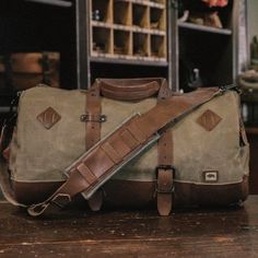 Dakota Vintage Travel Duffle Bag - Field Khaki Canvas Travel Bag With Luggage Sleeve For Outdoor Activities, Practical Travel Bag With Adjustable Strap For Overnight Trips, Canvas Travel Bag With Luggage Sleeve For Outdoor, Waxed Canvas Bags With Luggage Sleeve For Outdoor Activities, Waxed Canvas Bags With Luggage Sleeve For Outdoor, Rugged Waxed Canvas Bag For Outdoor Activities, Functional Travel Bag With Leather Trim For Outdoor, Large Capacity Satchel For Adventure, Canvas Travel Bag Backpack With Luggage Sleeve