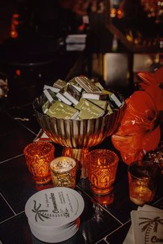 a table topped with lots of different types of chocolates and glasses on top of it