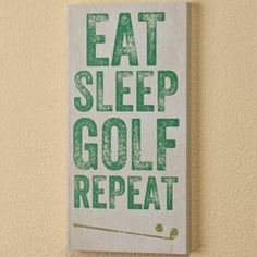 a sign that says eat sleep golf repeat on the wall above it is a green and white print