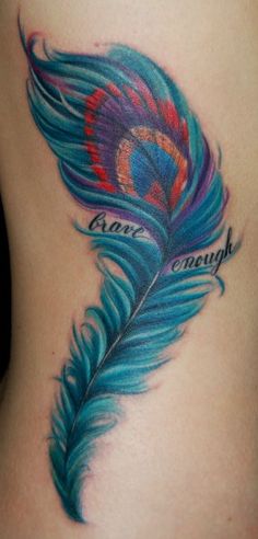 a woman's stomach with a colorful feather tattoo on it