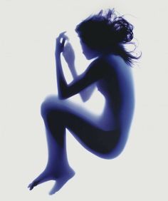 the silhouette of a naked woman is shown against a white background and blue hues