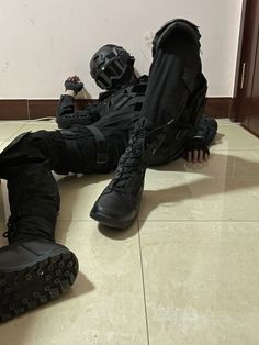 a pair of black boots sitting on the floor