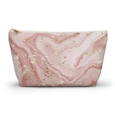 a pink and gold marble cosmetic bag with glitters on the inside, in front of a white background