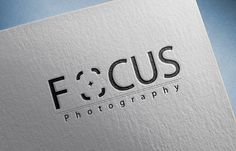 the focus photography logo is shown on top of a white paper with black letters and a blue background