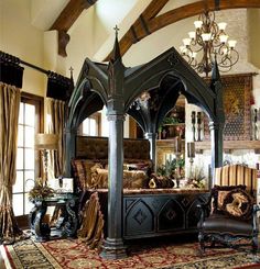 a bedroom with a canopy bed, chandelier and two couches in it