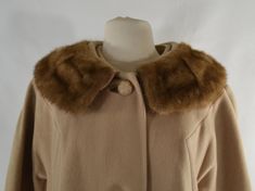 1960's/1970's Honey Beige Wool Winter Coat Beautiful honey beige wool coat with a real mink fur collar. The fur is full and soft.3 large celluloid buttons down the front.2 hip pockets.Fully linesLabel: Mary LaneMeasurements are taken flat;Shoulders: 17 inchesSleeve: 21 inchesCuff: 6 inchesNeck: 8 1/2 inchesBust: 21 inchesWaist: 21 1/2 inchesHips: 22 1/2 inchesLength (shoulder to hem): 40 1/2 inchesConditionEstate Fresh, needs cleaned.There are several small stains and area's are dinge. Vintage Cream Fur Coat With Faux Fur Trim, Vintage Beige Fur Coat, Classic Beige Fur Coat With Faux Fur Trim, Classic Beige Fur Coat With Faux Fur Lining, Beige Wool Coat, Wool Winter Coat, Wool Winter, Mink Fur, Fur Collar