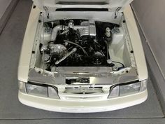 the engine compartment of a white sports car