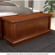 a bed with a wooden headboard and foot board on the floor next to a potted plant