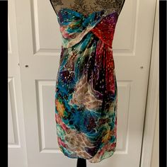 This A Beautiful Nwot Nicole Miller Strapless Multicolor Cocktail Dress. Sweetheart Neckline With Ruched Detail. Interior Includes Padded Cups. Hidden Back Zipper With Hook-And-Eye Closure. Lined. Material: 85% Silk, 15% Spandex; Lining: 100% Polyester Sleeveless Multicolor Print Mini Dress For Party, Multicolor Print Sleeveless Mini Dress For Party, Multicolor Strapless Dress For Night Out, Chic Fitted Multicolor Strapless Dress, Sleeveless Dresses With Vibrant Print For Evening, Sleeveless Evening Dress With Vibrant Print, Sleeveless Dress With Vibrant Print For Evening, Multicolor Fitted Strapless Dress, Chic Strapless Multicolor Dress