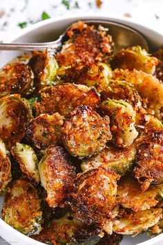 a bowl filled with cooked brussel sprouts on top of a table