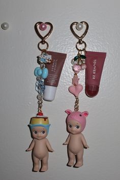 two key chains with small items attached to them