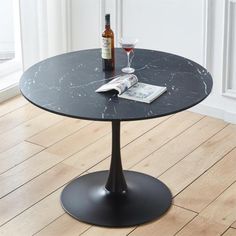 a table with a wine glass and bottle on it