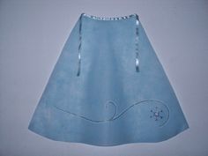 a light blue skirt hanging on a white wall with an embroidered design and beading