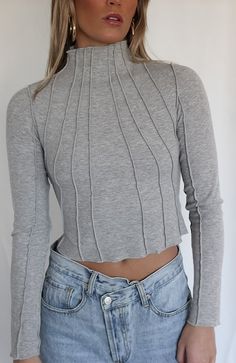 COLOR: HEATHER GREY DETAILS Features a ribbed knit fabric, long sleeves, slim fit, mock neckline and parallel stripe detailing stretch 95% Acrylic, 5% Spandex Please refer to the care label for garment care instructions SIZE & FIT: runs TTS, model wears size S MODEL INFO: HEIGHT 5’6, WAIST 25in, BUST 32in Bolero Top, Mock Neckline, City Girl, Fit Check, Care Label, Girl Top, S Models, Turtles, Heather Grey